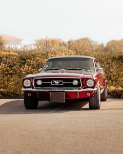 A red car parked on the side of a road